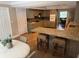 Charming kitchen with granite countertops, seating at bar, and open access to a nearby dining area at 7108 East Rd, Lakeland, FL 33809