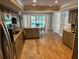 Well lit kitchen with updated cabinets, granite counter tops, stainless steel appliances, and views to the pool at 7108 East Rd, Lakeland, FL 33809