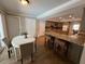 Kitchen with a dining nook, breakfast bar, granite counters, and views into other rooms at 7108 East Rd, Lakeland, FL 33809