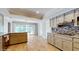Spacious kitchen featuring granite counters, modern appliances, and access to the outdoor pool area at 7108 East Rd, Lakeland, FL 33809