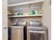 Convenient laundry room with modern stainless steel front load washer and dryer at 7108 East Rd, Lakeland, FL 33809