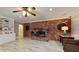 Beautiful fireplace with wood mantle and brick surround and built-in shelves on the side at 7108 East Rd, Lakeland, FL 33809