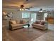 Bright and airy living space with two sofas, a glass coffee table, and access to the lanai at 7108 East Rd, Lakeland, FL 33809