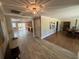 Open-concept living room showcasing seamless flow, hardwood floors, and elegant dining area at 7108 East Rd, Lakeland, FL 33809