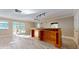 Large living room with custom wood bar, access to the lanai, and new tile floors throughout at 7108 East Rd, Lakeland, FL 33809