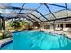 Beautiful enclosed pool area with brick paver patio and turquoise blue water at 7108 East Rd, Lakeland, FL 33809