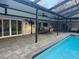 Screened pool area with large patio featuring an outdoor dining and seating area at 7108 East Rd, Lakeland, FL 33809