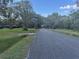 Street view with mature trees lining the road at 7108 East Rd, Lakeland, FL 33809