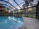 A sparkling swimming pool with screened enclosure and brick patio at 7108 East Rd, Lakeland, FL 33809