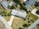 An aerial view of this lovely house displays its long driveway, well-maintained lawn, and surrounding green landscape at 72 Rockefeller Dr, Ormond Beach, FL 32176