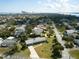An aerial view captures a charming house in a neighborhood, close to a beautiful cityscape and bay, and mature landscaping at 72 Rockefeller Dr, Ormond Beach, FL 32176