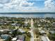Scenic aerial view showcasing the coastline and a neighborhood with many houses near a large body of water at 72 Rockefeller Dr, Ormond Beach, FL 32176