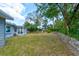 Spacious backyard featuring a charming gazebo, rock wall, and lush green lawn, perfect for outdoor living at 72 Rockefeller Dr, Ormond Beach, FL 32176
