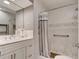 Bright bathroom with double vanity, marble tile, and shower with safety features and decorative accents at 72 Rockefeller Dr, Ormond Beach, FL 32176