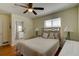 Light filled bedroom features hardwood floors, natural lighting, and neutral walls at 72 Rockefeller Dr, Ormond Beach, FL 32176