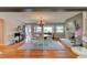 Open-concept living space with luxury flooring, a wood burning fireplace, and a view into the living room at 72 Rockefeller Dr, Ormond Beach, FL 32176