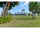 Beautiful view of house with palm trees and large front lawn at 72 Rockefeller Dr, Ormond Beach, FL 32176