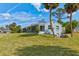 Charming single-story home with well-maintained lawn, mature trees, and blue paint at 72 Rockefeller Dr, Ormond Beach, FL 32176