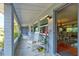 Inviting front porch with rocking chairs and open door to a beautiful dining room and living room at 72 Rockefeller Dr, Ormond Beach, FL 32176