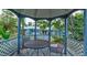 Covered gazebo offering a charming outdoor seating area with mature trees at 72 Rockefeller Dr, Ormond Beach, FL 32176