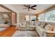 Cozy living room with a large sectional sofa, and a view into the dining room and front door at 72 Rockefeller Dr, Ormond Beach, FL 32176