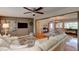 Spacious living room with luxury flooring, a large sectional sofa, and view into the dining room at 72 Rockefeller Dr, Ormond Beach, FL 32176