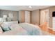 Comfortable bedroom featuring a dresser, closet, natural light, and warm hardwood flooring at 72 Rockefeller Dr, Ormond Beach, FL 32176