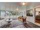 Bright sunroom filled with natural light, complemented by wicker furniture, and hardwood flooring at 72 Rockefeller Dr, Ormond Beach, FL 32176