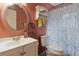 Small bathroom featuring a toilet, sink, medicine cabinet, and patterned shower curtain at 749 Cassadaga Rd, Lake Helen, FL 32744