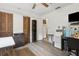 Bedroom with laminate floors, closet, and TV; door leads to additional room at 749 Cassadaga Rd, Lake Helen, FL 32744