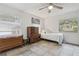 Bedroom featuring neutral colors, ceiling fan and two windows for natural light at 749 Cassadaga Rd, Lake Helen, FL 32744