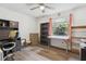 Comfortable bedroom featuring a ceiling fan, a window, and wood-look laminate flooring at 749 Cassadaga Rd, Lake Helen, FL 32744
