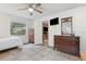 Well lit bedroom with a ceiling fan and brick fireplace in view at 749 Cassadaga Rd, Lake Helen, FL 32744