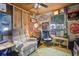 Cozy bonus room with reclining chair and vintage decor, perfect for relaxation and entertainment at 749 Cassadaga Rd, Lake Helen, FL 32744