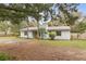 Charming single-story home with a brick chimney, well-maintained lawn, and a welcoming entrance at 749 Cassadaga Rd, Lake Helen, FL 32744