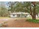 Charming single-story home with palm trees and a well-maintained front yard at 749 Cassadaga Rd, Lake Helen, FL 32744