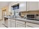 Bright kitchen area featuring stainless steel appliances and natural light at 749 Cassadaga Rd, Lake Helen, FL 32744