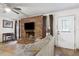 Inviting living room featuring a brick fireplace and access to a white front door at 749 Cassadaga Rd, Lake Helen, FL 32744