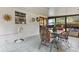 Enclosed patio with white walls, tile floor, and dining table at 749 Cassadaga Rd, Lake Helen, FL 32744