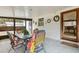 Covered patio features tile flooring, a dining table, and wooded views at 749 Cassadaga Rd, Lake Helen, FL 32744