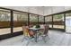 Enclosed patio with tile flooring, seating, and screened windows at 749 Cassadaga Rd, Lake Helen, FL 32744