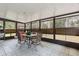 Covered outdoor patio with tile floors, seating, and natural light at 749 Cassadaga Rd, Lake Helen, FL 32744