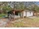 Outdoor shed featuring a covered porch and gated entry, providing ample storage and workspace at 749 Cassadaga Rd, Lake Helen, FL 32744