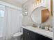 Bright bathroom features classic vanity, updated lighting, stylish mirror, and shower/tub combination at 755 Fairlawn Dr, Orange City, FL 32763