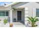 Inviting home entrance featuring a well-lit front door and lush landscaping at 755 Fairlawn Dr, Orange City, FL 32763