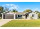 Charming single-story home with a two car garage, manicured lawn, and fresh landscaping at 755 Fairlawn Dr, Orange City, FL 32763