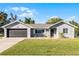 Charming single-story home with a well-manicured lawn, neutral siding, and an attached two-car garage at 755 Fairlawn Dr, Orange City, FL 32763