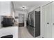 Well-lit kitchen featuring granite countertops, stainless steel appliances, and white cabinets at 755 Fairlawn Dr, Orange City, FL 32763