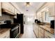 Well-lit kitchen featuring granite countertops, stainless steel appliances and tile flooring at 755 Fairlawn Dr, Orange City, FL 32763