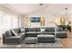 Bright living room features vaulted ceilings, a large sectional, and plenty of natural light from the large windows at 755 Fairlawn Dr, Orange City, FL 32763